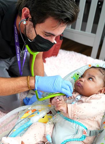 Image of a doctor checking on an infant